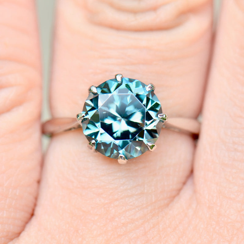 Ring with a blue gemstone on a hand